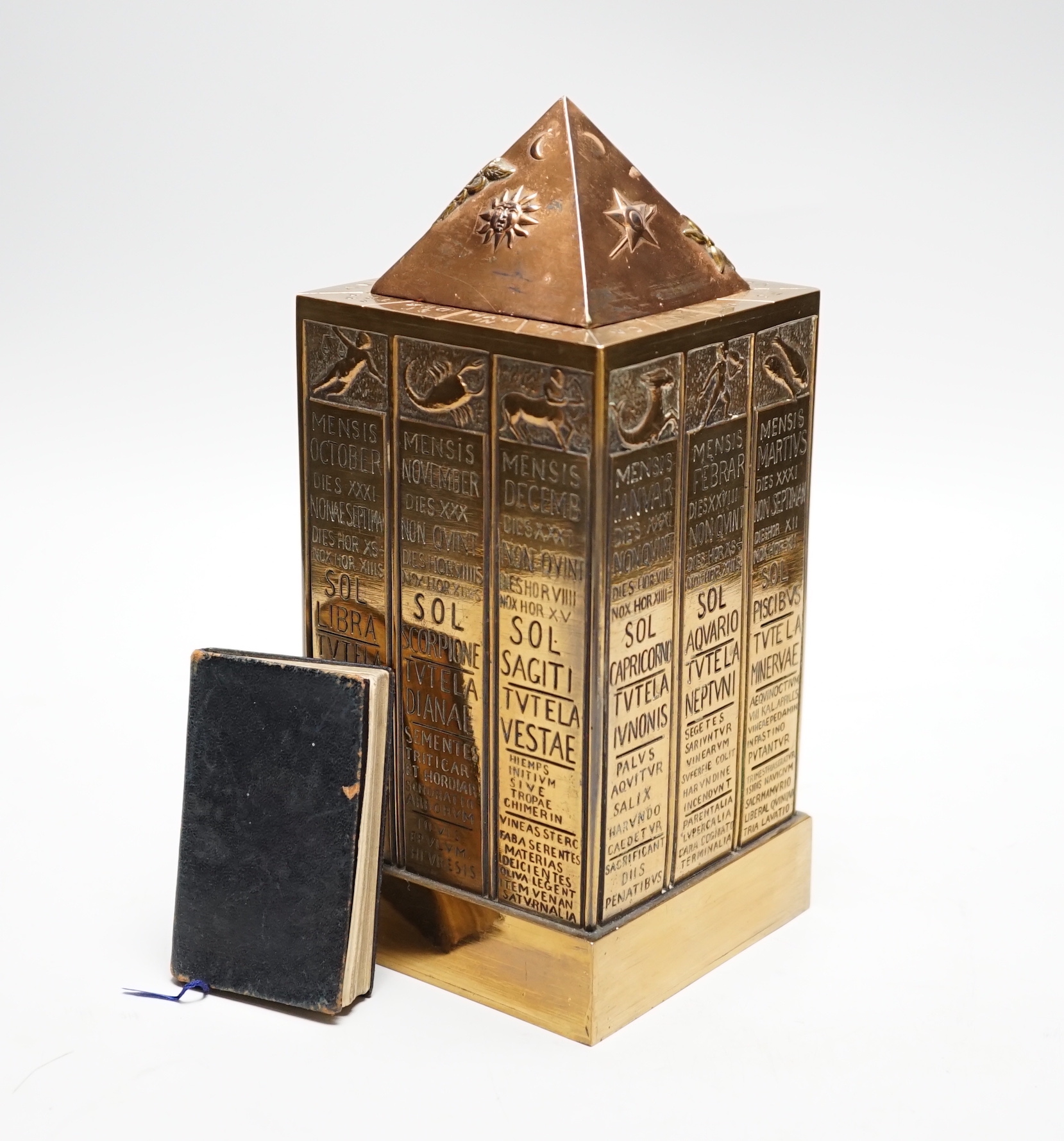 A German astrological cast stand together with a Masonic ceremony book, tallest 23cm